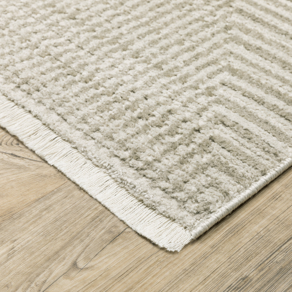 5' X 8' Ivory Beige Taupe And Tan Geometric Power Loom Stain Resistant Area Rug With Fringe